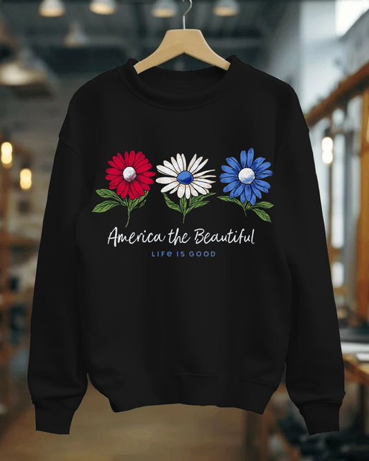 Black sweatshirt with floral design and 'America the Beautiful' text on a hanger.