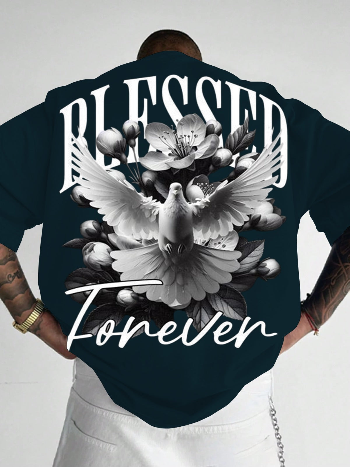 Person wearing a dark blue shirt with 'Blessed Forever' design featuring a dove and flowers.
