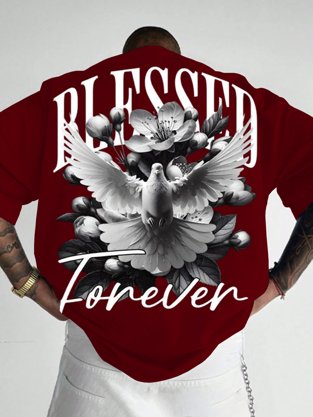 Person wearing a red t-shirt with 'Blessed Forever' design featuring a dove and flowers.
