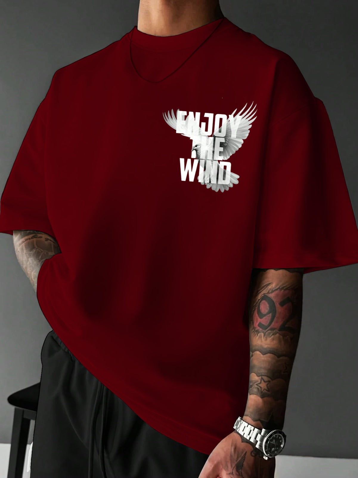 Red t-shirt with 'Enjoy the Wind' design on a gray background