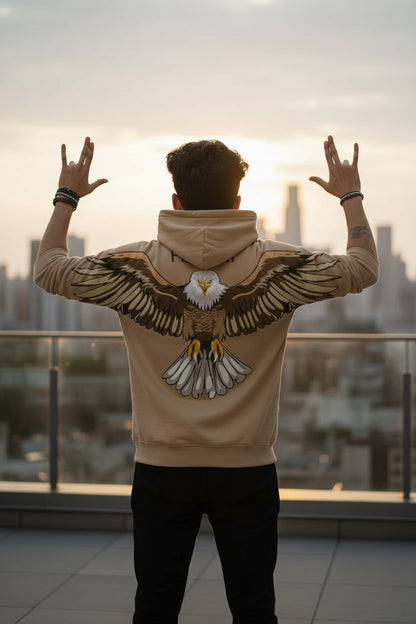 Person wearing a hoodie with an eagle design, standing on a rooftop with a cityscape in the background.