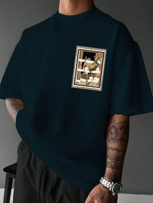 Person wearing a dark blue t-shirt with a graphic design on a gray background