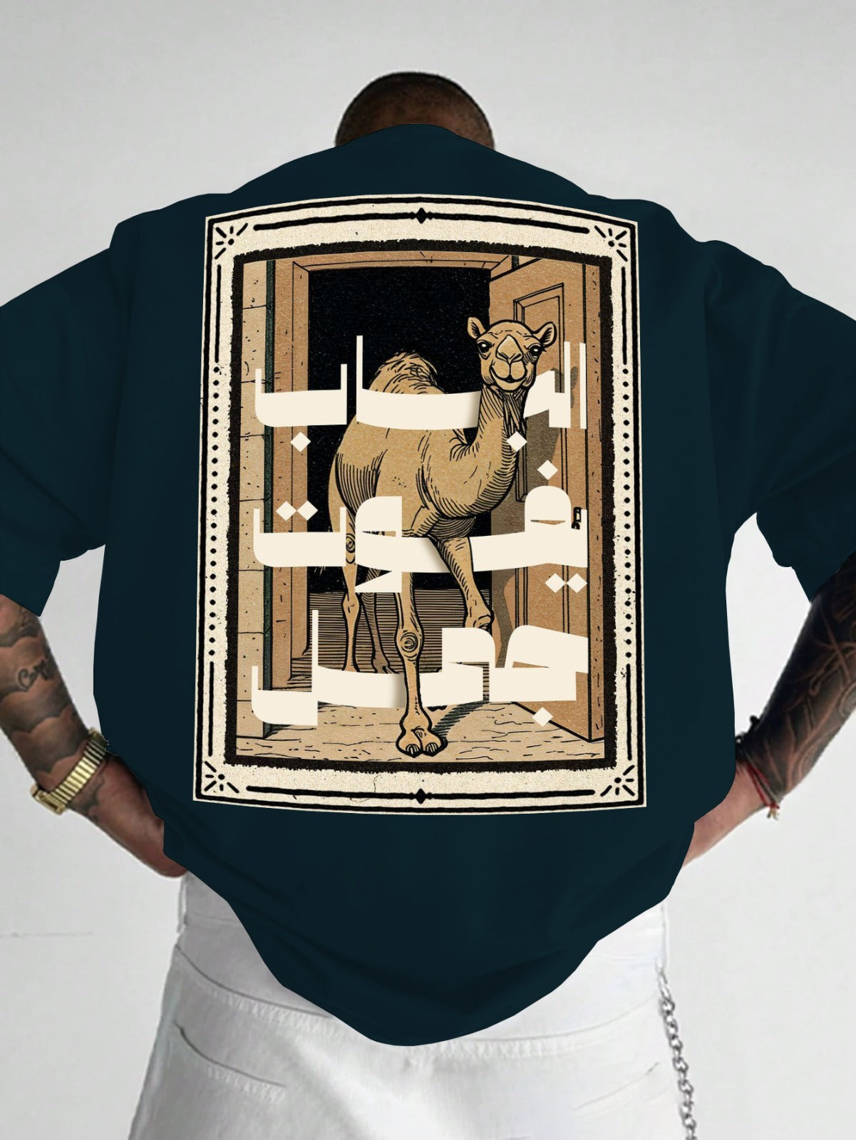 Person wearing a dark blue shirt with a camel illustration on the back against a white background