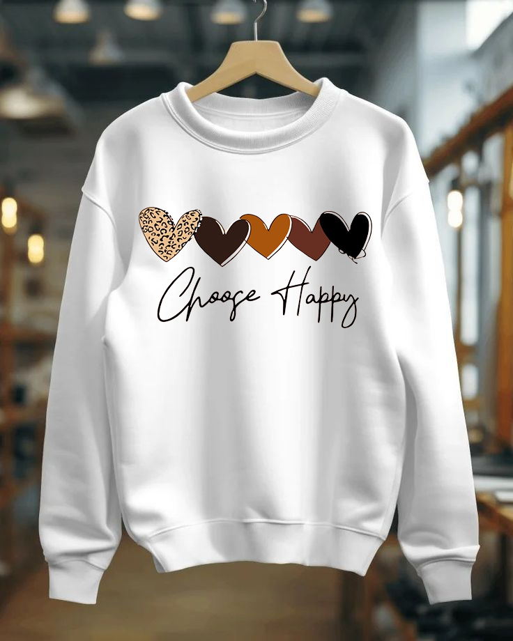 White sweatshirt with colorful heart designs and 'Choose Happy' text on a hanger.