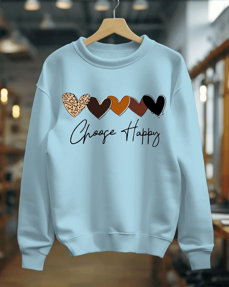 Light blue sweatshirt with colorful hearts and 'Choose Happy' text on a hanger.