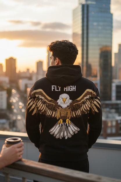 Person wearing a hoodie with an eagle design and 'Fly High' text, standing on a rooftop with a cityscape in the background.