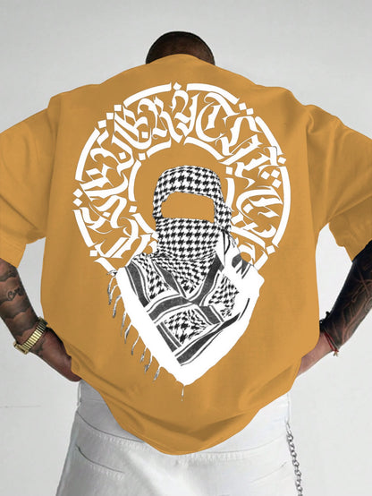 Person wearing a mustard yellow t-shirt with a graphic design on the back.