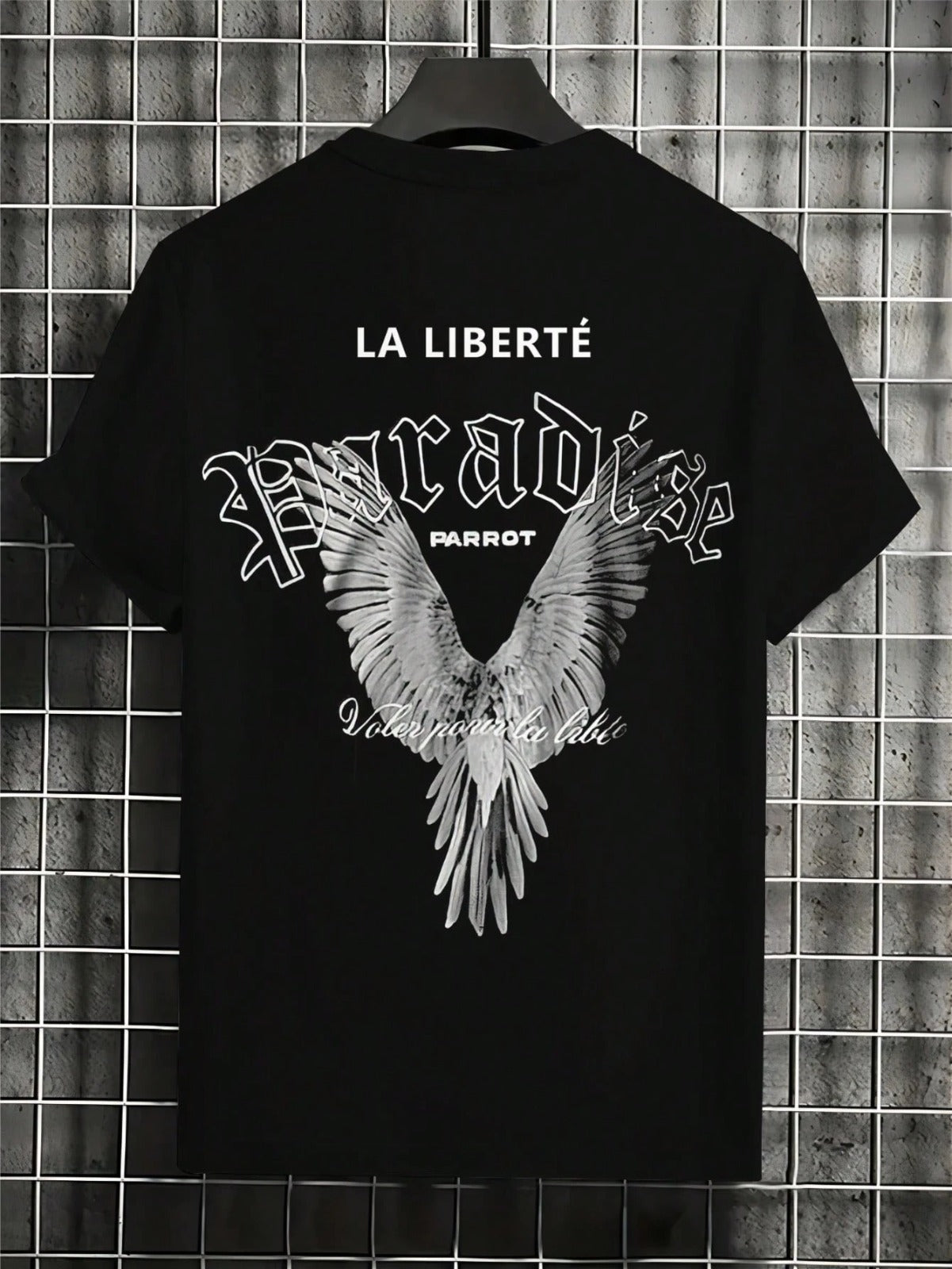 Black t-shirt with white graphic design and text on a tiled wall background