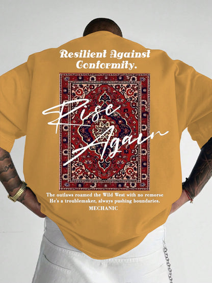 Person wearing a mustard yellow t-shirt with a graphic and text on the back, on a plain background.