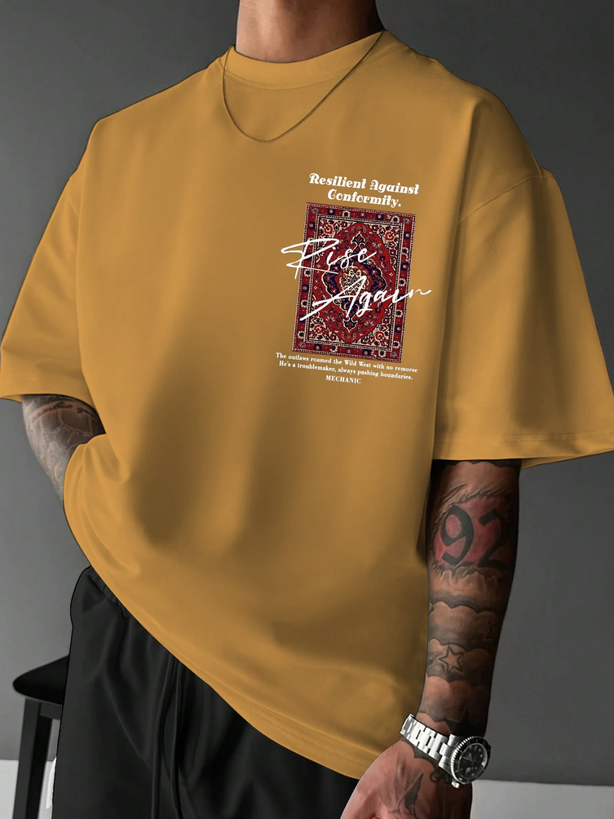 Yellow t-shirt with graphic design and text on a gray background