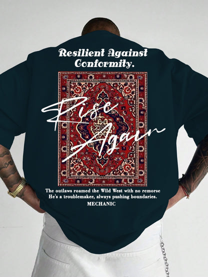 Person wearing a dark blue shirt with text and a pattern on the back, standing against a plain background.