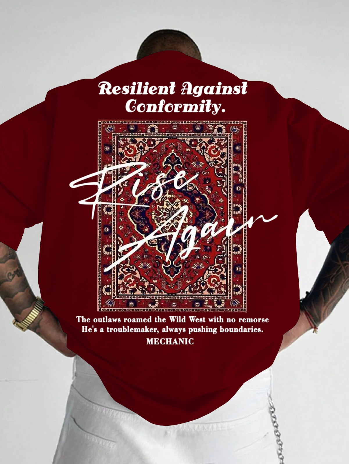 Person wearing a red shirt with text and design, standing against a white background